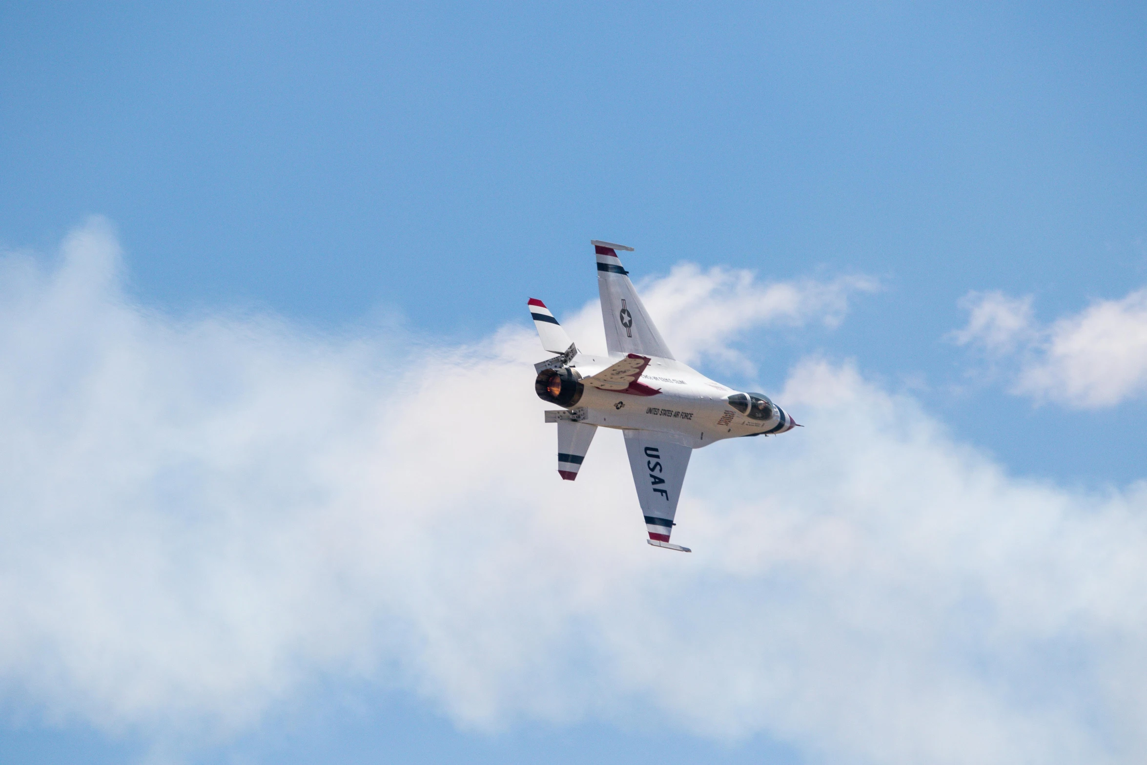 a airplane flying through a cloud filled sky