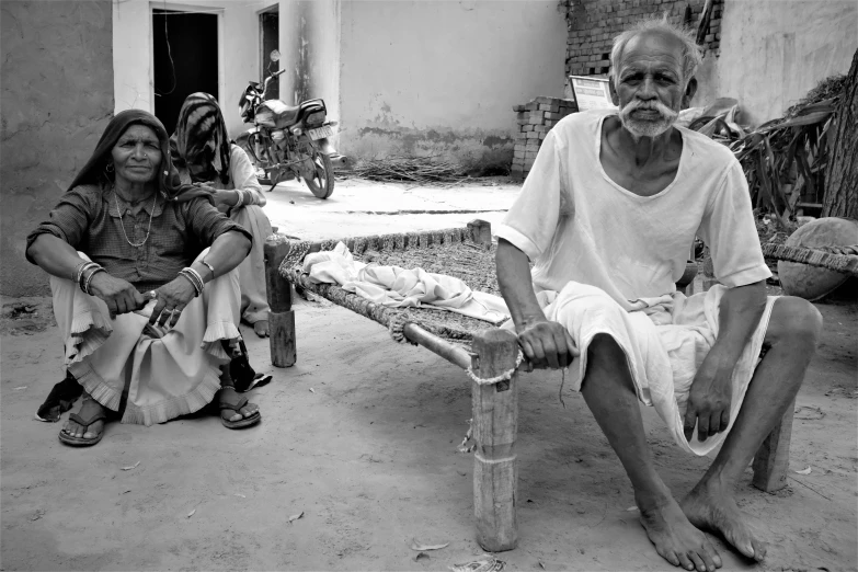 a man and woman sit on a bench