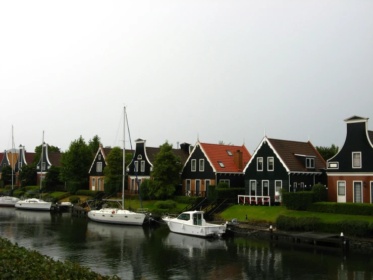 a body of water with small boats next to houses