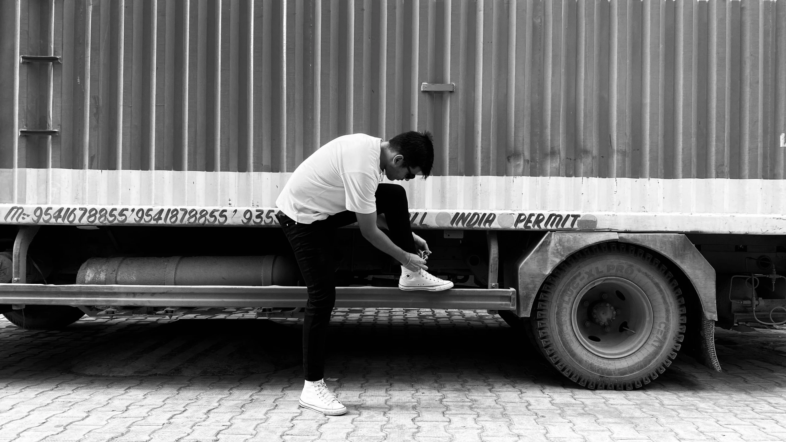 a man is sitting on a metal bench