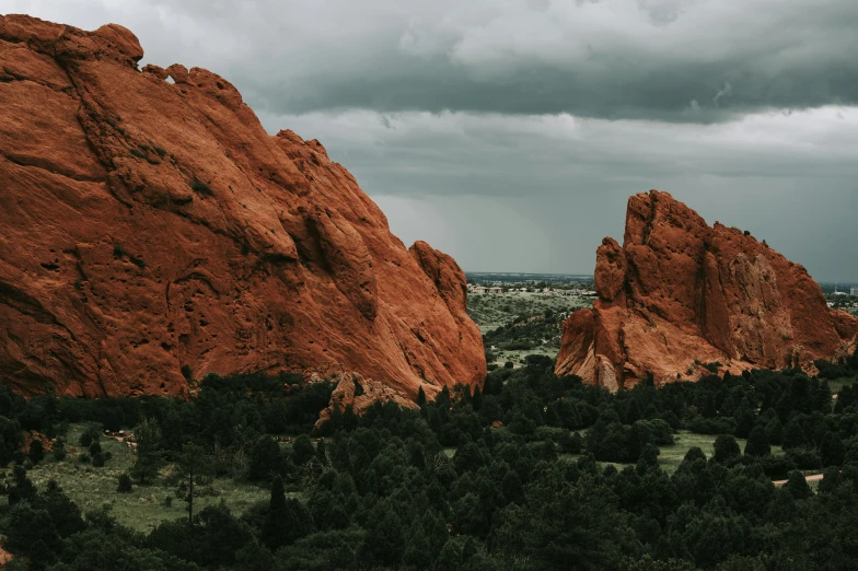 an open field with some red rocks near by