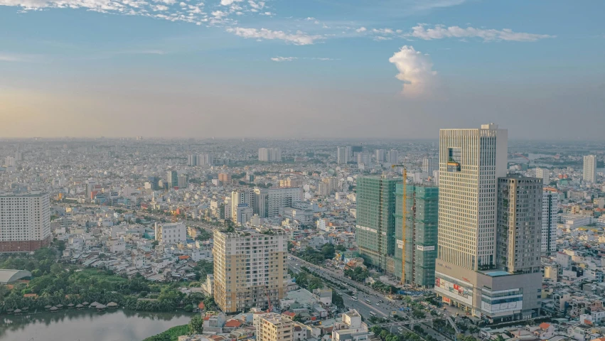 a bird - eye view of several tall buildings on a city with a lake below