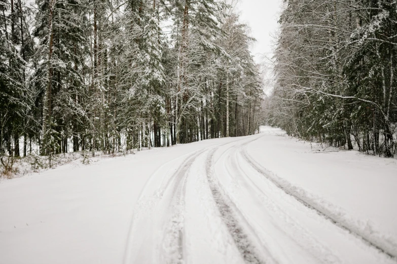 the path on the side of the road is covered in snow