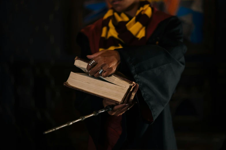 a person holding an open book and pointing it at the viewer