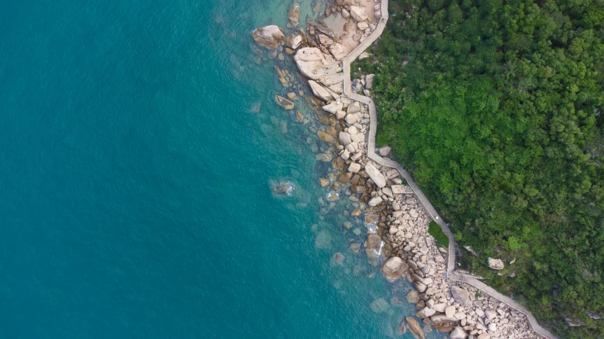 a shoreline with several rocks and trees along the shoreline