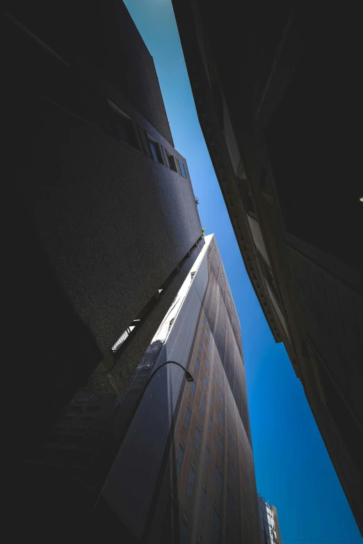 the corner of two large buildings showing upward upward