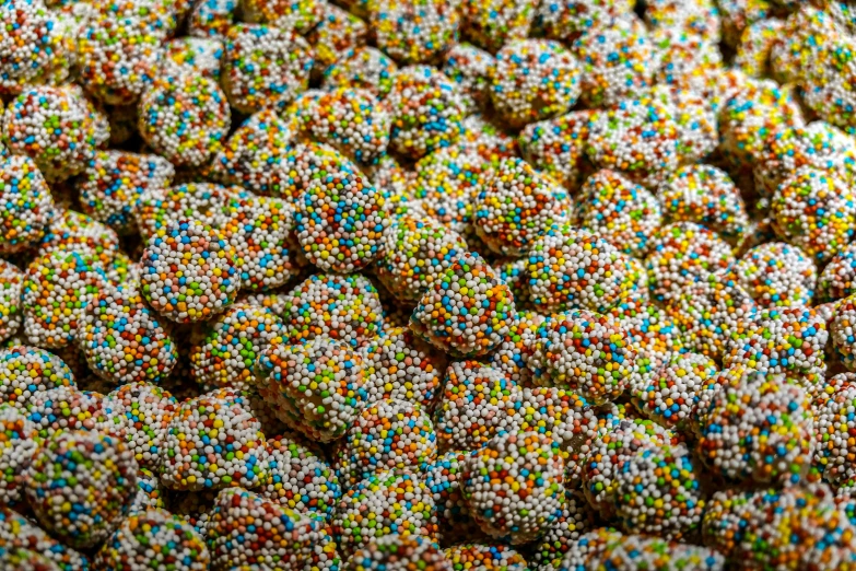 close up s of sprinkled donuts with green, yellow and blue circles