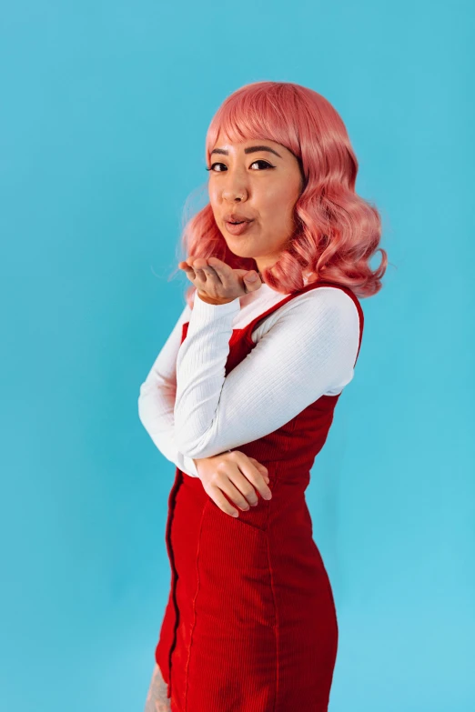 a girl wearing pink hair is posing