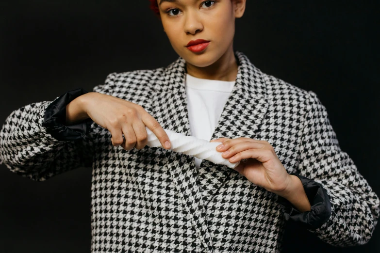 a woman in a black and white checkered jacket