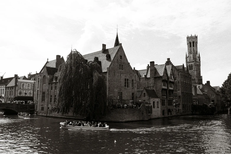 boats are traveling along a large canal near a church