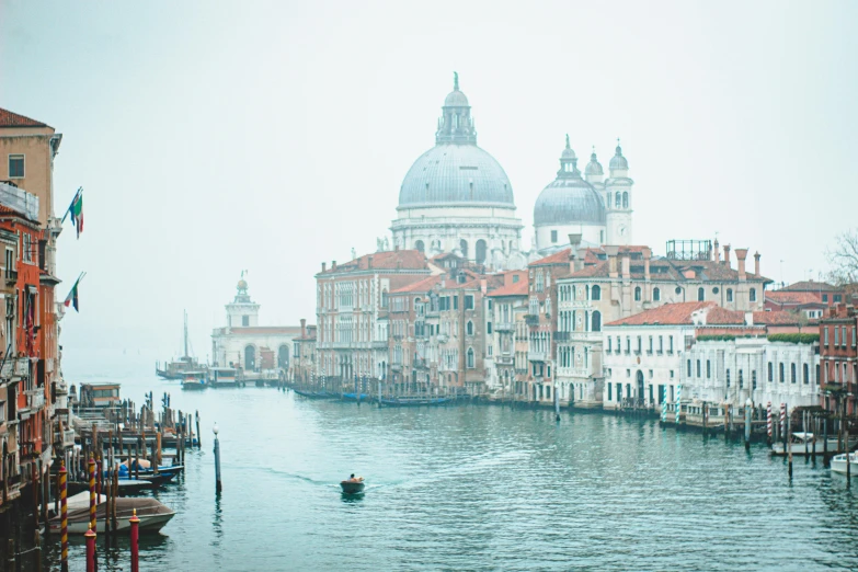 a body of water near buildings and a tall tower