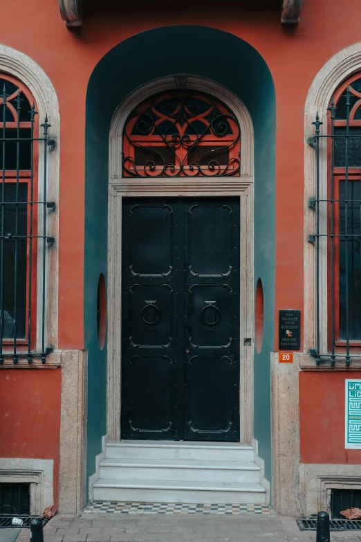 a red building with two doors and windows