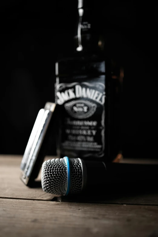 a microphone and two bottles of alcohol on a table
