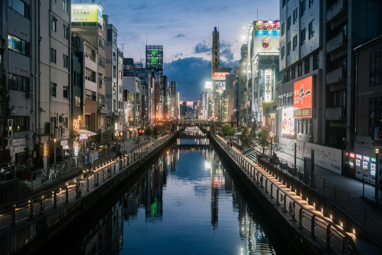 a city filled with lots of tall buildings next to a river