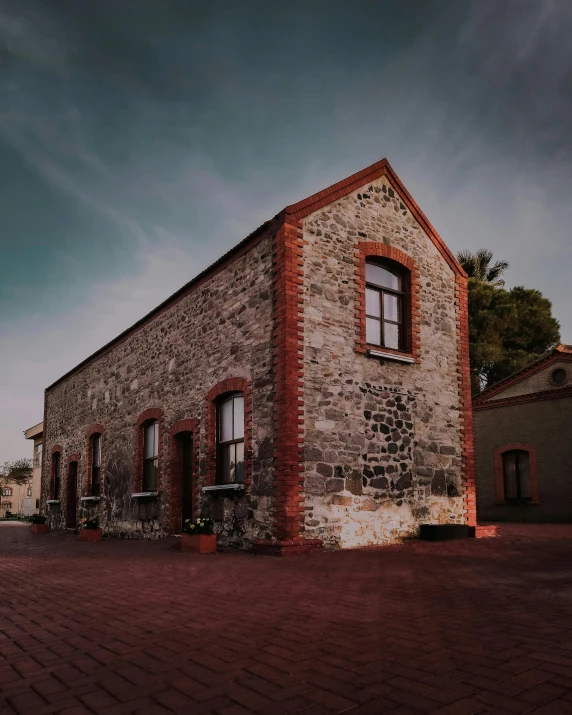 a brick building with lots of windows and brick walkway