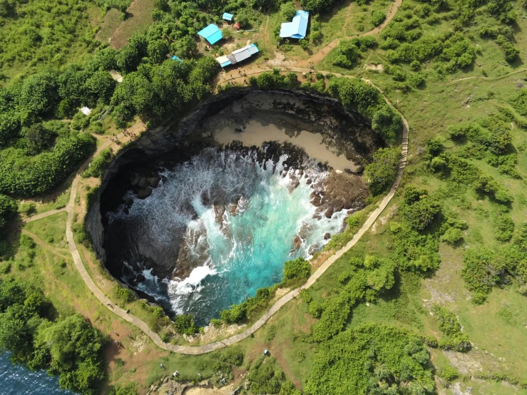 aerial po of an island with a cave near water