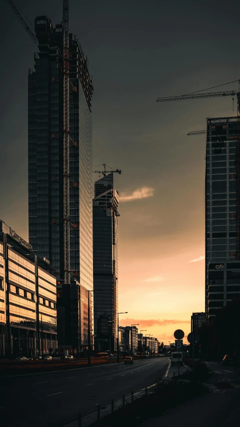 a row of buildings under construction in the evening