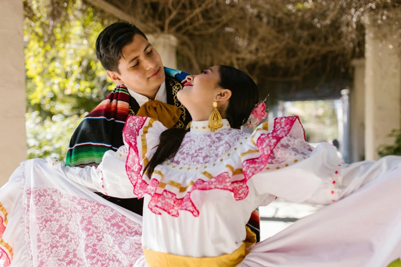 a man and woman wearing different outfits