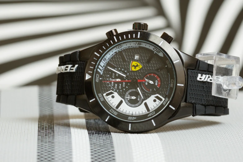 a mens watch with a black face and yellow numbers