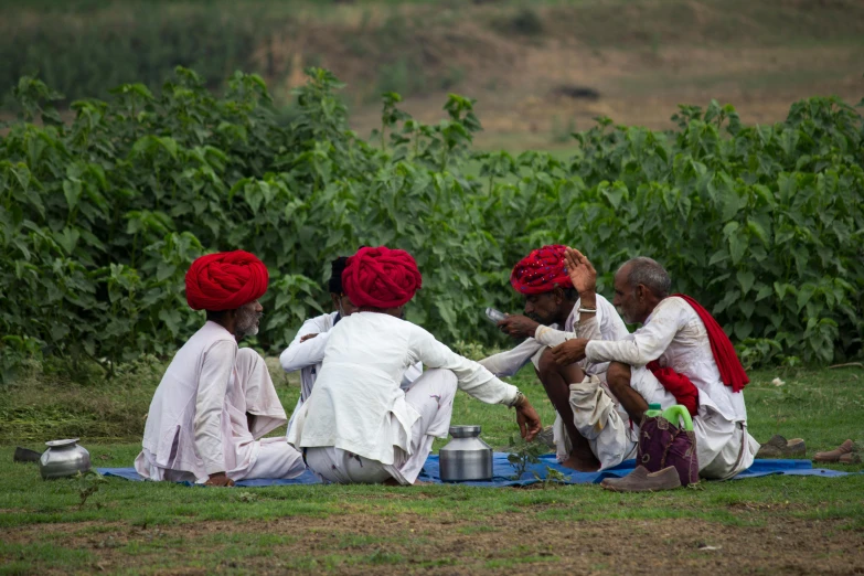 a group of women sitting on top of a field