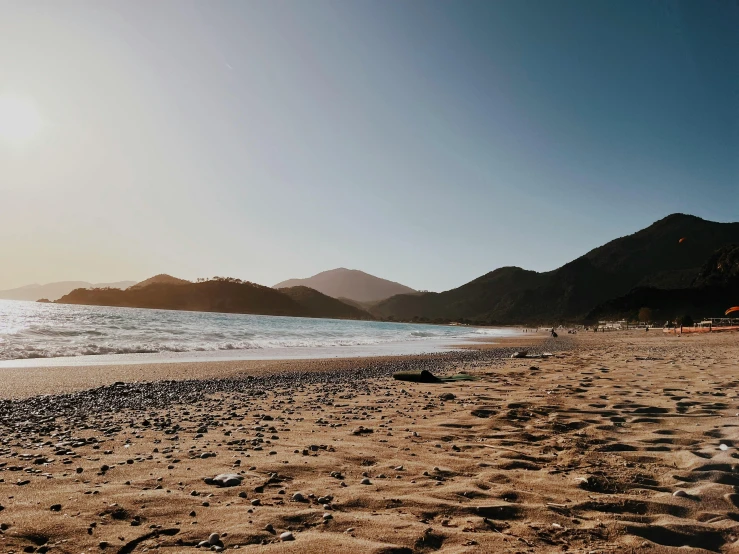 an empty sandy beach with footprints in the sand