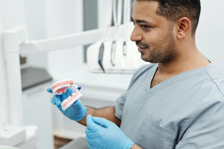 a dentist taking care of a patient who is getting dental floss