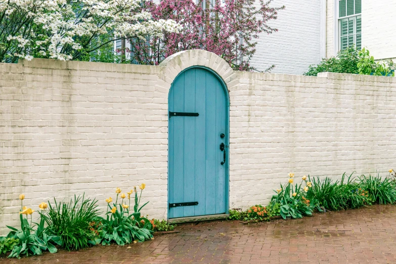 there is a brick wall with a blue door