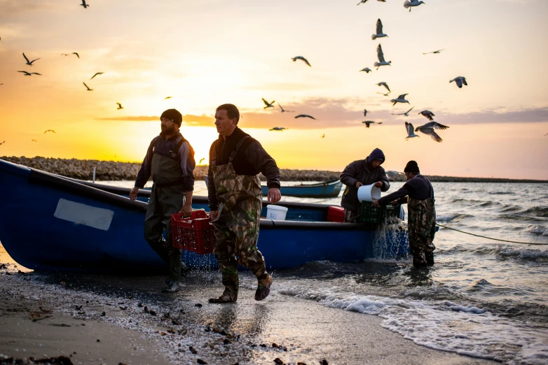 three men getting a boat out of the water