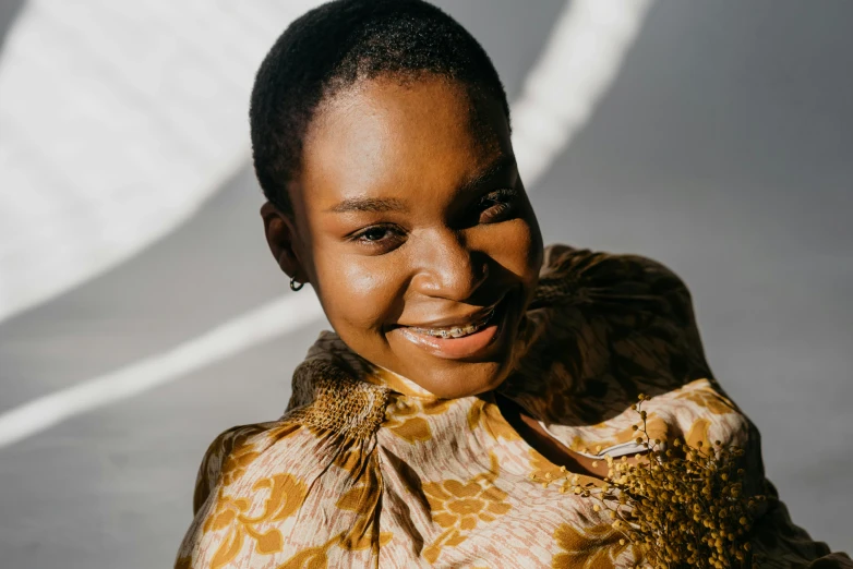 a girl in a patterned blouse is posing for a pograph