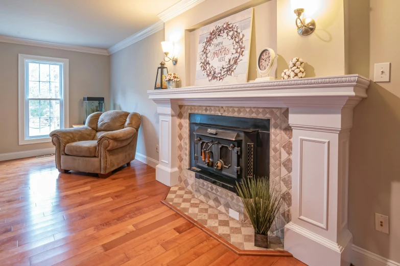 a beautiful fireplace with two chairs sitting by it