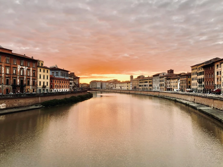 a canal that is under some clouds and orange