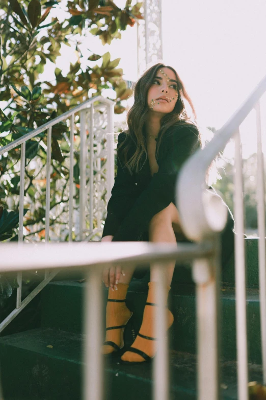 an attractive woman in tight yellow socks sitting on some stairs