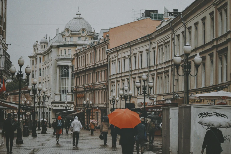 a couple of people that are standing under an umbrella