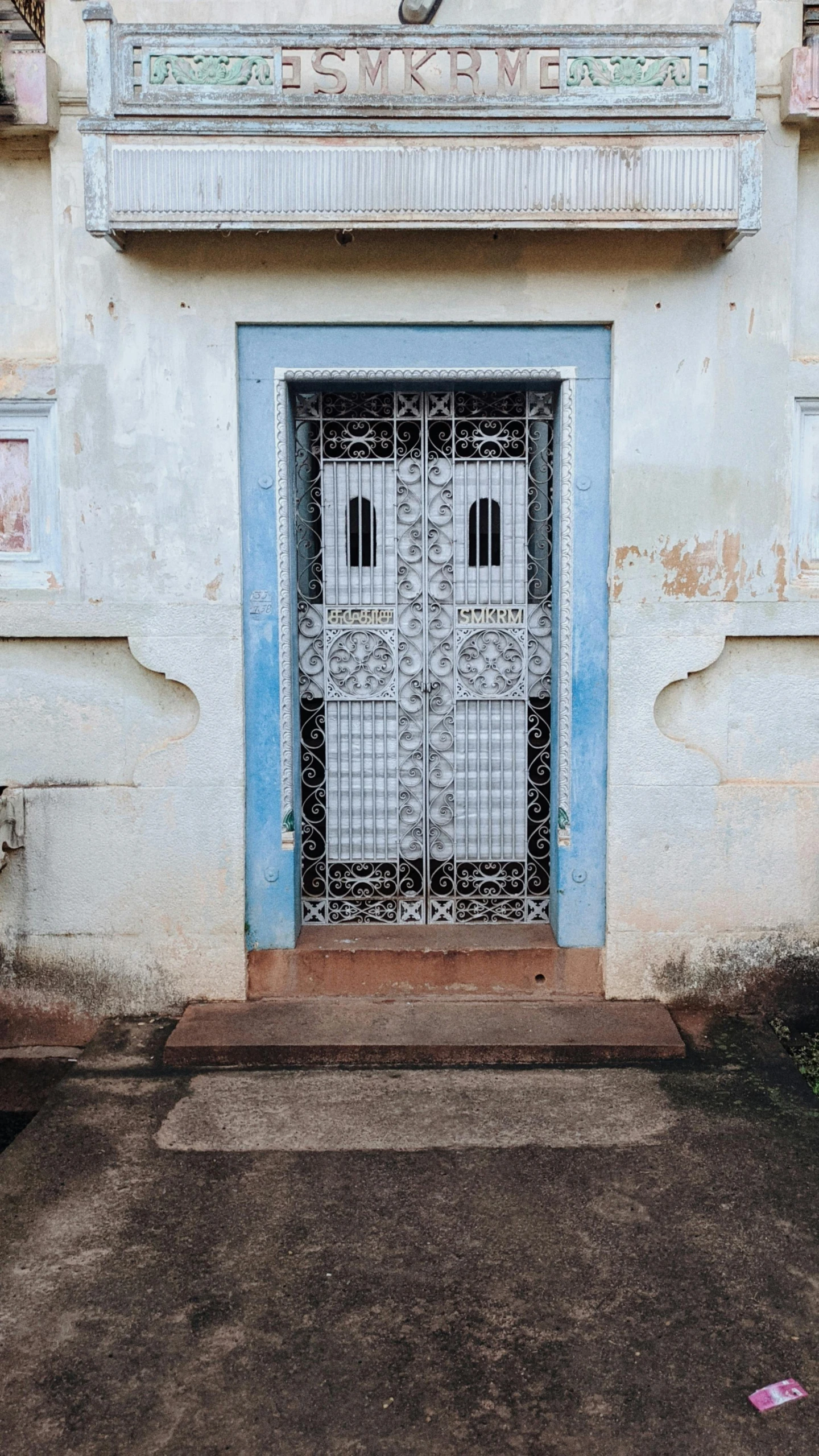 a building with a blue door and a white front