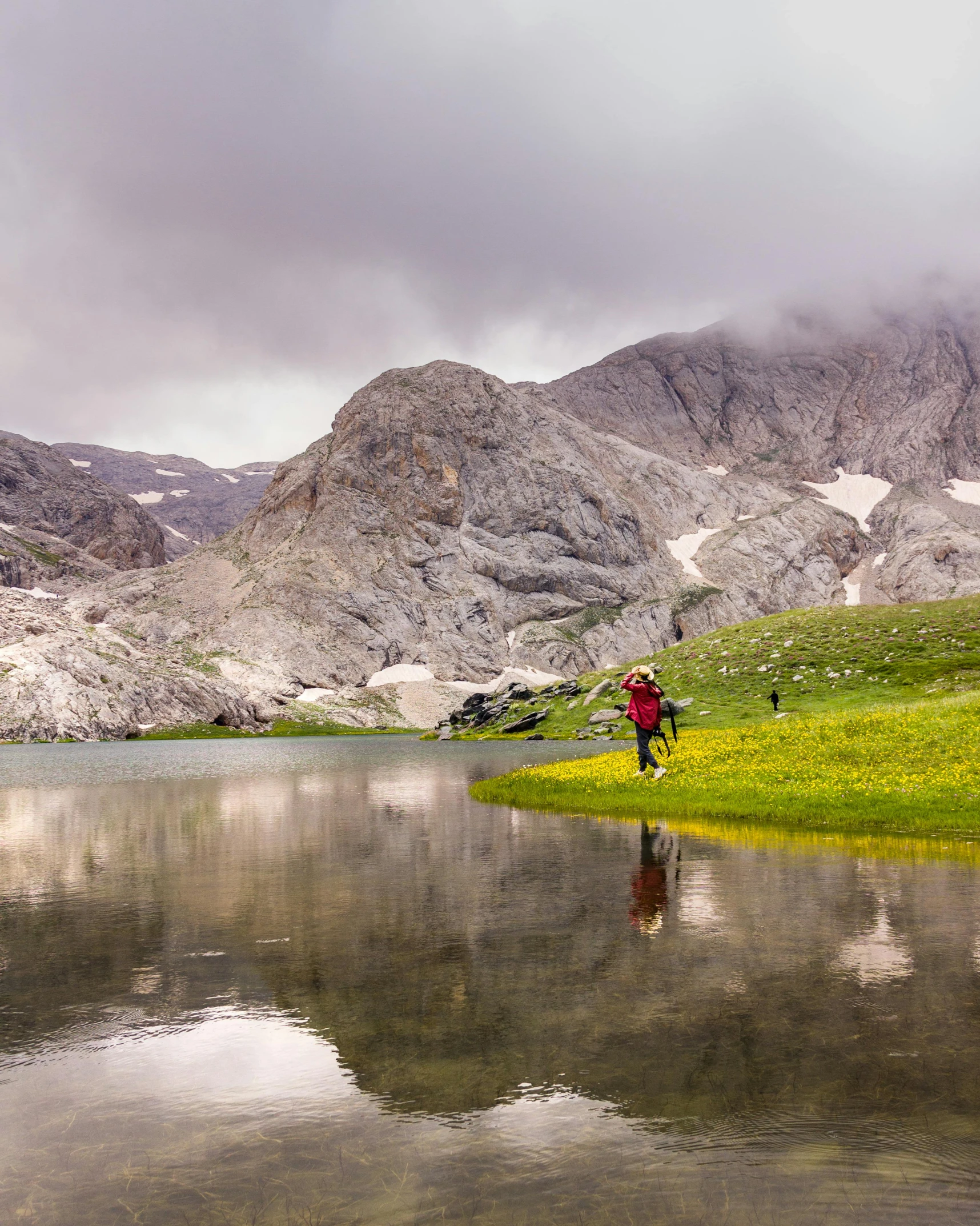 a lake is in the foreground with some mountains in the background