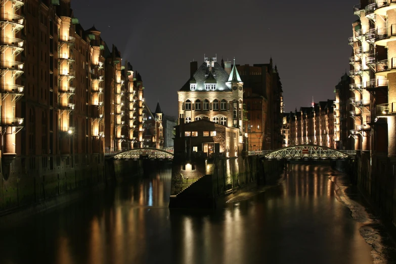 some buildings water lights a bridge and some water