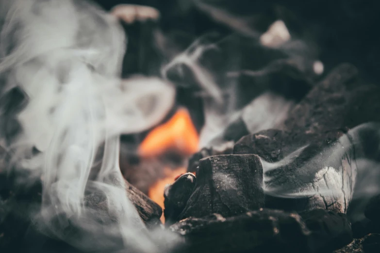 smoke and flame in the form of rocks and logs