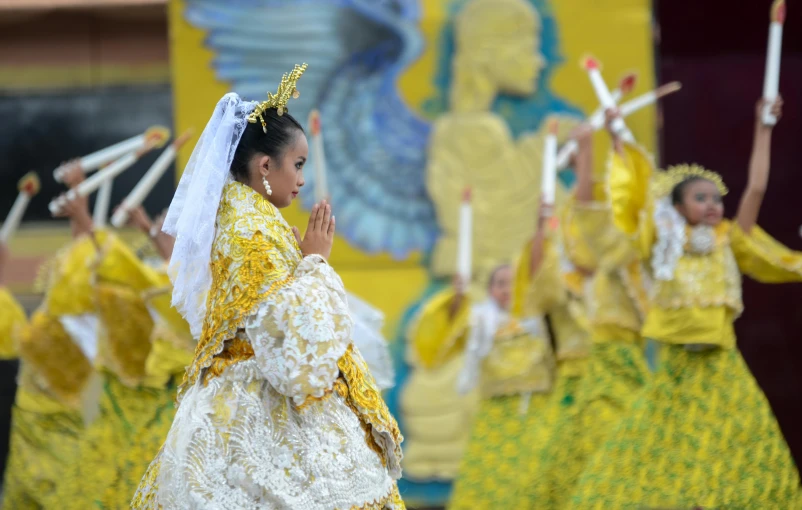 two women in elaborate yellow dresses are performing