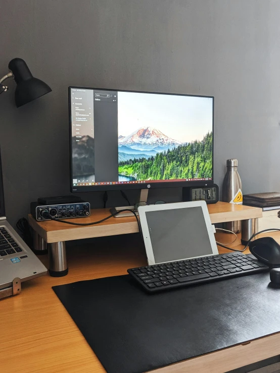 a desk with a laptop and a monitor