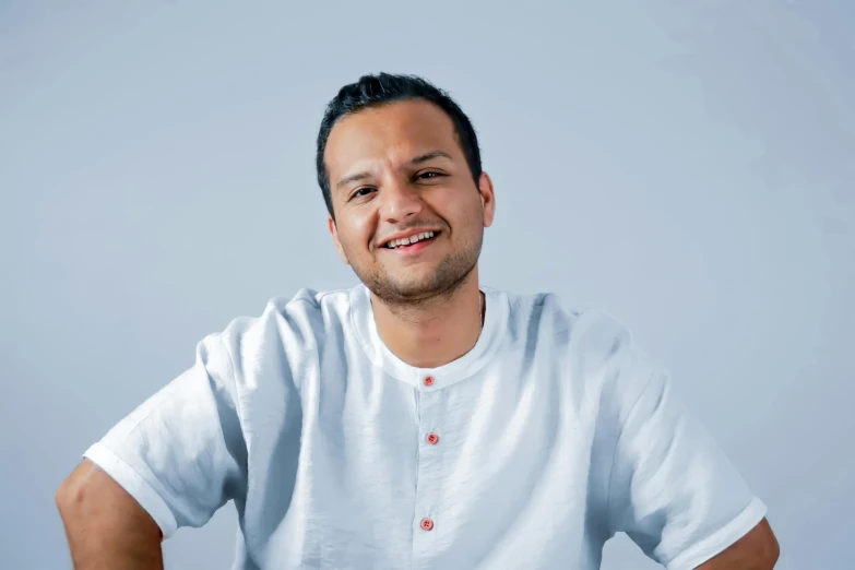 man sitting down with a smirk on his face