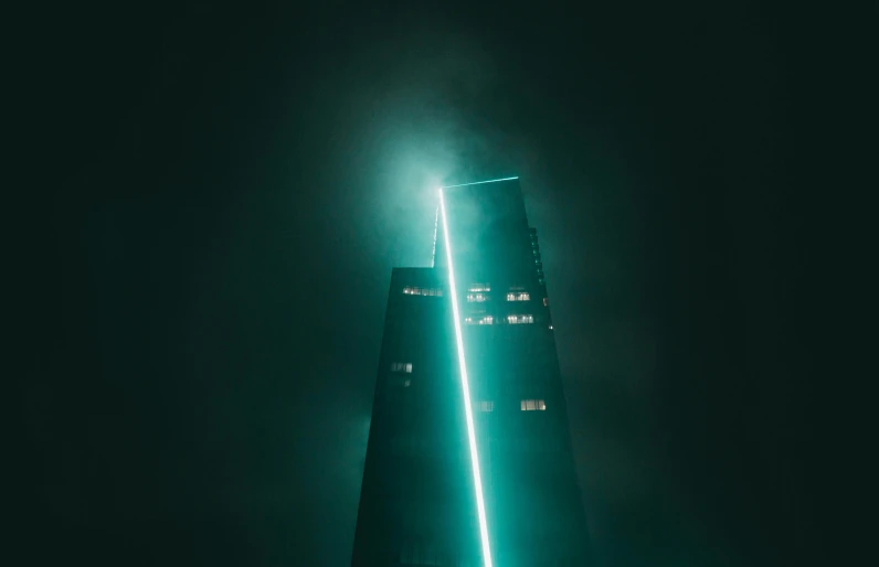 a building lit up green in the night