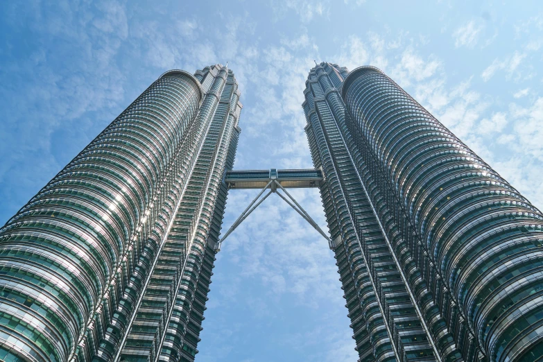 two tall buildings towering up into the sky