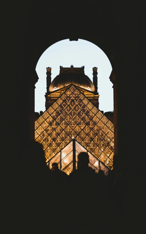 a s from the inside of a large building with the top of a pyramid in the distance