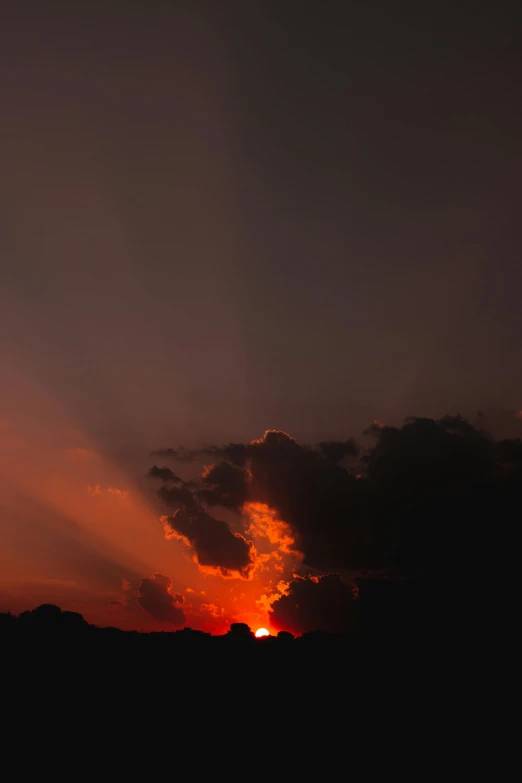 sunset over mountains with cloudy sky and some birds