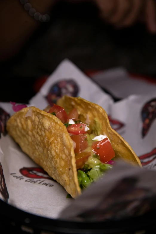 a taco on top of a plate covered in lettuce and tomatoes