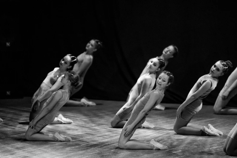 several ballet dancers are posing on stage and looking up