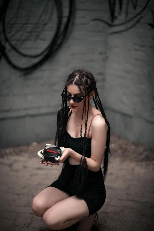 a woman wearing long ids is holding a football