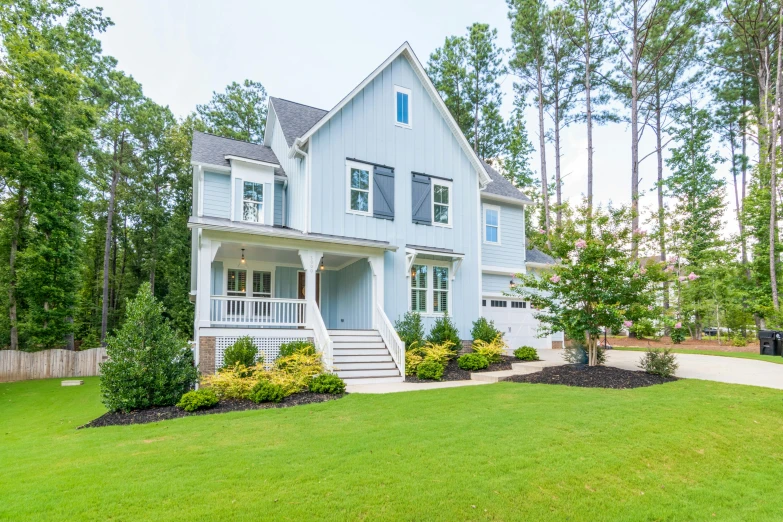 the front of a house surrounded by trees