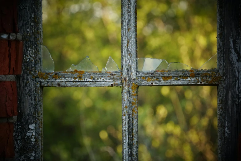 a broken window with paint on it