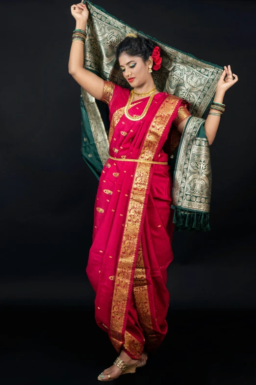 a beautiful indian woman posing in front of a black background